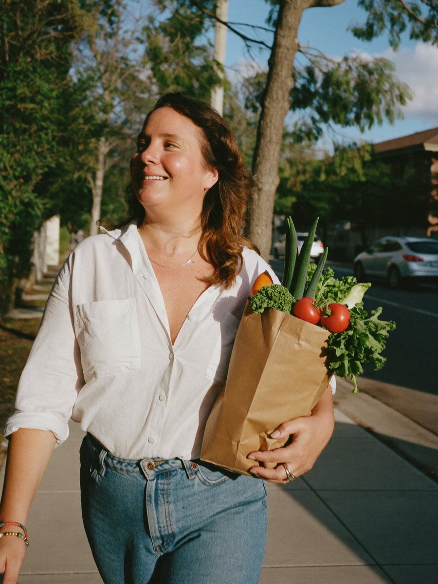 A woman walking home with groceries