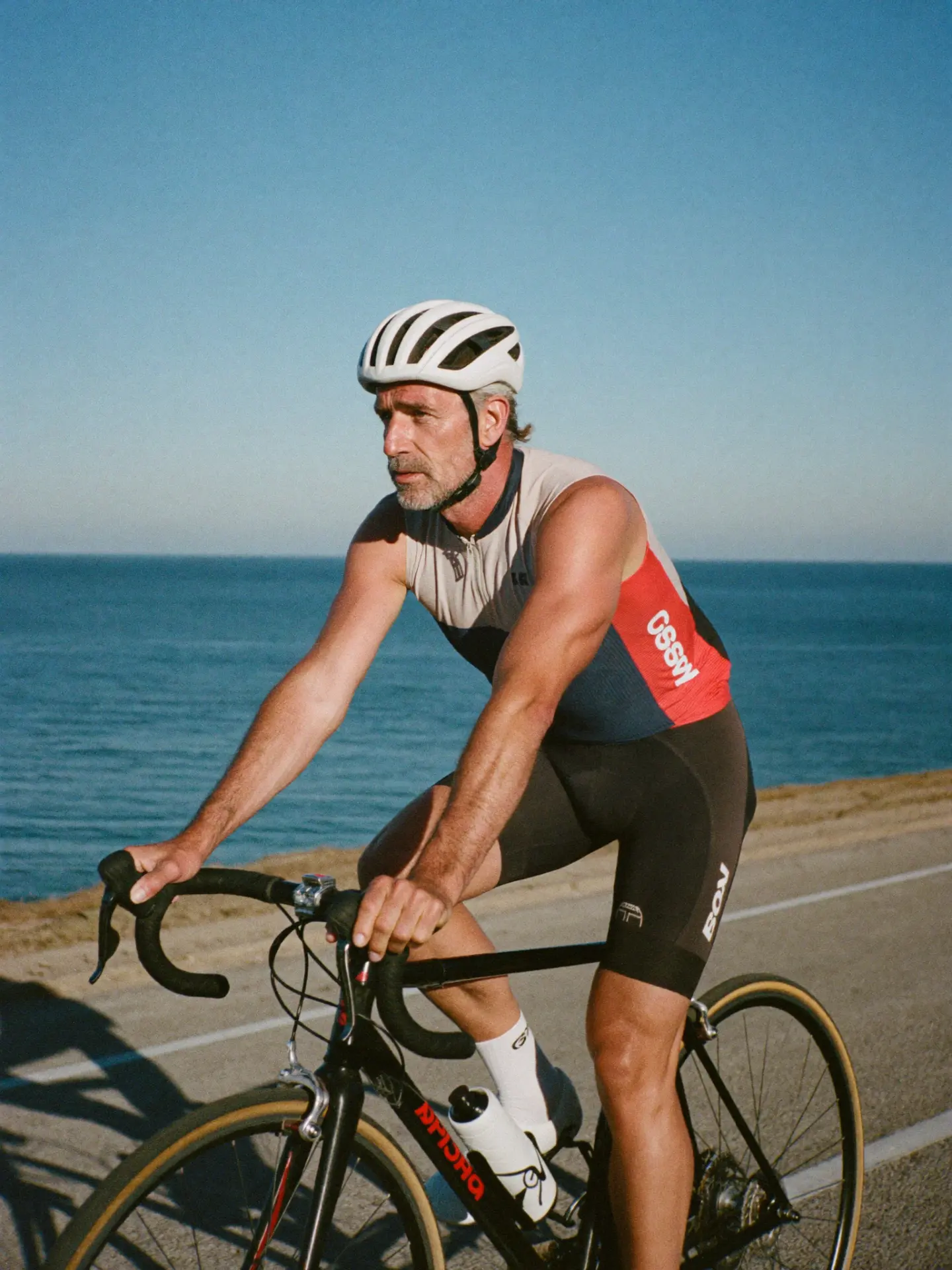 A cyclist riding along a coastal road